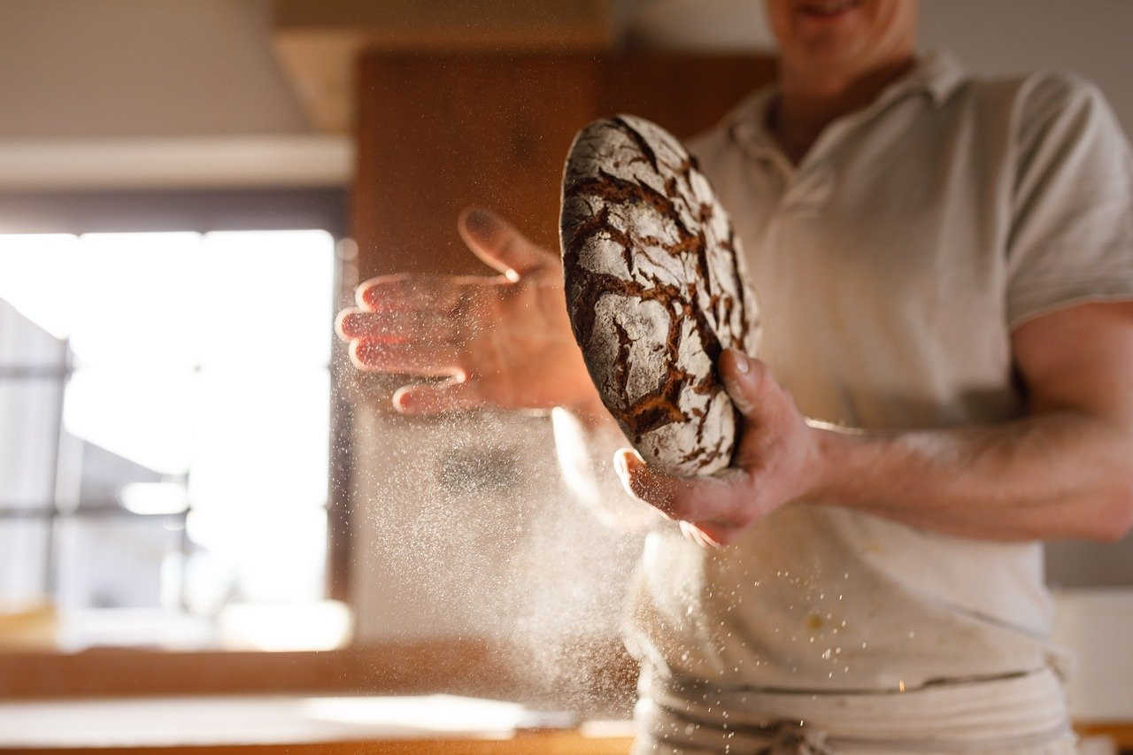Baker patting bread