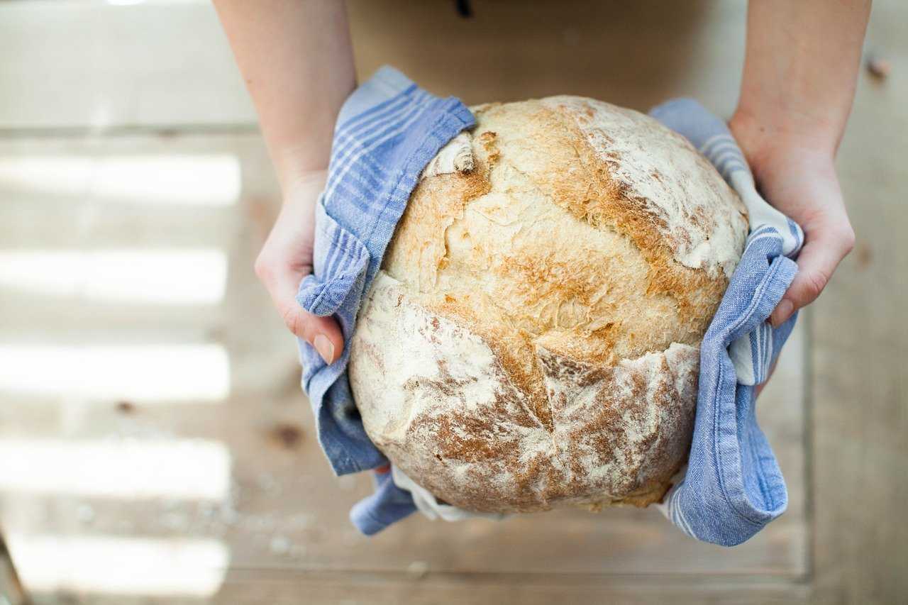 Baker holding warm bread